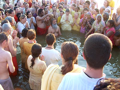 His Holiness Swamiji, surrounded by devotees, takes a holy dip in Ganges